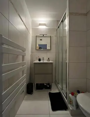 a white bathroom with a sink and a shower at Studio meublé, les tambourins in Cannes