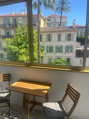 a table and chairs in front of a window at Studio meublé, les tambourins in Cannes