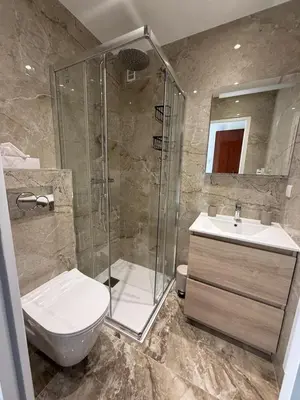 a bathroom with a shower and a toilet and a sink at Luxury 1 Bed Apt Seafront Escape in Cannes in Cannes