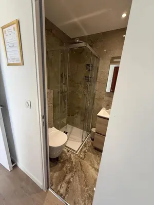 a bathroom with a glass shower and a toilet at Luxury 1 Bed Apt Seafront Escape in Cannes in Cannes