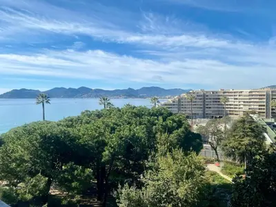 a view of the water and a large building at Luxury 1 Bed Apt Seafront Escape in Cannes in Cannes