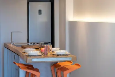 a kitchen with a counter with plates and bowls on it at 1-Br 75m Duplex with Pool in Cannes