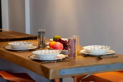 a wooden table with bowls of fruit on it at 1-Br 75m Duplex with Pool in Cannes