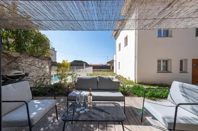 a patio with two couches and a glass table at 1-Br 75m Duplex with Pool in Cannes
