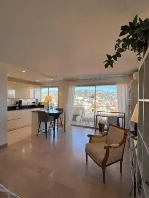 a living room with a kitchen and a dining room at Celeste Cannes Centre 700m du Palais des Festivals in Cannes
