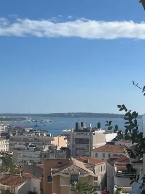 a view of a city with the ocean in the background at Celeste Cannes Centre 700m du Palais des Festivals in Cannes