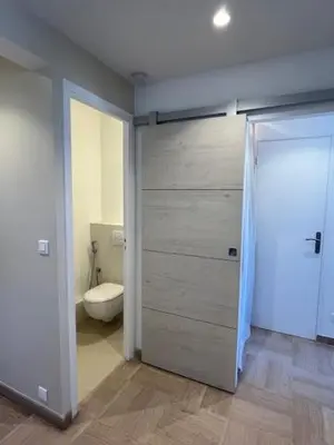 a bathroom with a toilet and a sliding door at Celeste Cannes Centre 700m du Palais des Festivals in Cannes