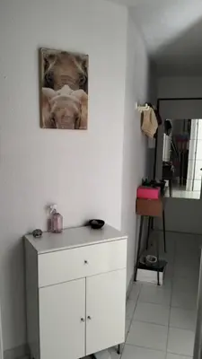 a white dresser in a room with a picture on the wall at CARIBOU T2 piscine - Axelle Loc'Appart in Cannes