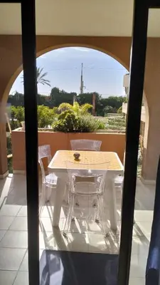 a table and chairs on a balcony with a view at CARIBOU T2 piscine - Axelle Loc'Appart in Cannes