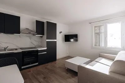 a small living room with a couch and a kitchen at Perfect studio in Cannes in Cannes