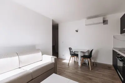 a living room with a couch and a table and chairs at Perfect studio in Cannes in Cannes