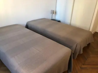 two beds sitting next to each other in a room at merimée 4G in Cannes
