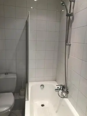 a bathroom with a shower and a tub and a toilet at merimée 4G in Cannes