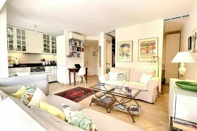 a living room with a couch and a table at magnifique 2 pièces parc de la croisette in Cannes