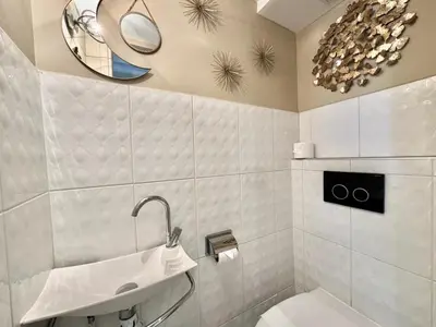 a bathroom with a sink and a mirror at 1-bedroom apartment with balcony and sea view on La Croisette in Cannes