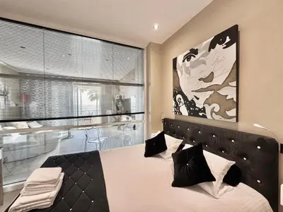 a bedroom with a bed and a large window at 1-bedroom apartment with balcony and sea view on La Croisette in Cannes