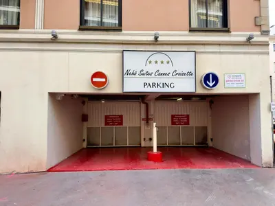 a building with a garage with a parking sign at Cannes Évasion by SCLS Locations in Cannes
