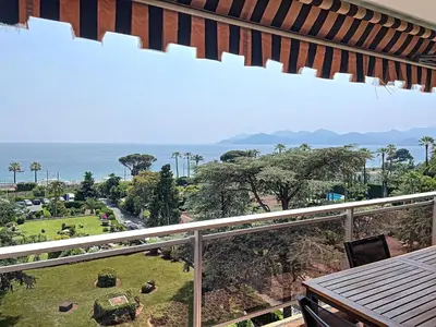 a balcony with a view of the ocean at A 2 pas des plages du Midi 300L in Cannes