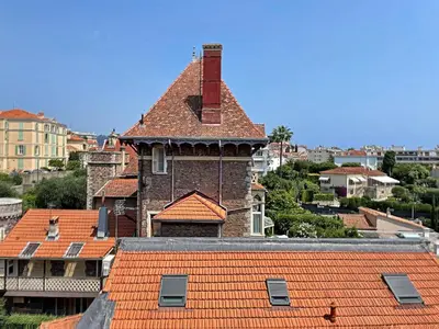a building with a chimney on top of a roof at A 2 pas des plages du Midi 300L in Cannes