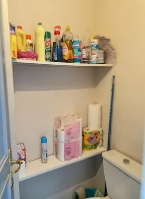 a bathroom with a shelf with toiletries on it at A 2 pas des plages du Midi 300L in Cannes