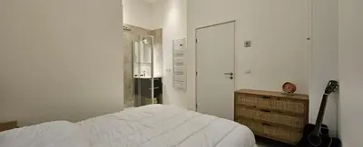 a bedroom with a bed and a guitar in it at F3 ground floor, Hypercentre 2 min from Palace in Cannes