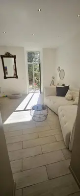 a living room with a couch and a table at F3 ground floor, Hypercentre 2 min from Palace in Cannes