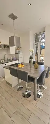 a kitchen with a table and chairs in a kitchen at F3 ground floor, Hypercentre 2 min from Palace in Cannes
