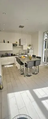 a kitchen with a table and chairs on a tile floor at F3 ground floor, Hypercentre 2 min from Palace in Cannes