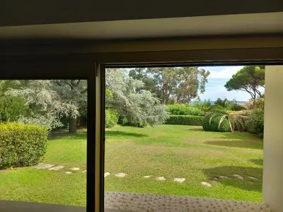 a view of a yard from a window at Studio et chambre sur jardin et mer in Cannes