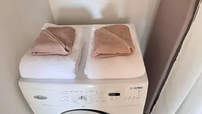 two towels are sitting on top of a washing machine at Studio 3étoiles à 10 min du Centre - Calme in Cannes