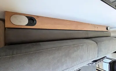 a couch with a clock on top of it at Studio 3étoiles à 10 min du Centre - Calme in Cannes
