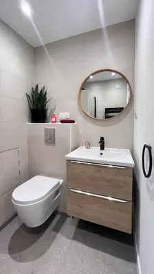 a bathroom with a toilet and a sink and a mirror at Studio 3étoiles à 10 min du Centre - Calme in Cannes