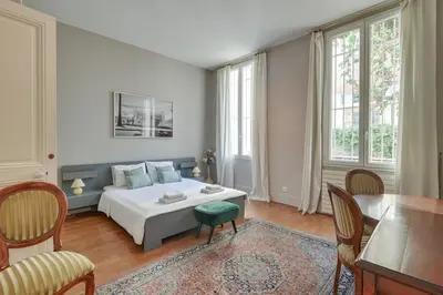 a bedroom with a bed and a table and chairs at Pura Vida in Cannes