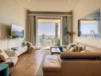 a living room with a couch and a view of the ocean at Pura Vida in Cannes