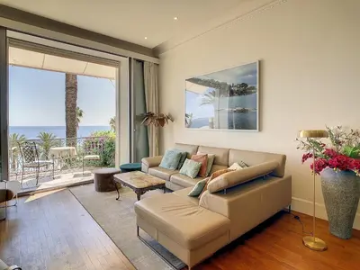 a living room with a couch and a large window at Pura Vida in Cannes