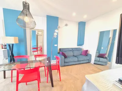 a living room with a glass table and red chairs at Luxury 3 bed 2 bath flat Cannes Croisette in Cannes