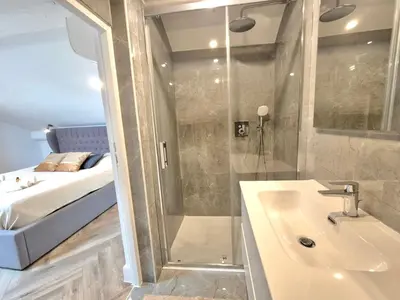 a bathroom with a shower and a sink and a bed at Luxury 3 bed 2 bath flat Cannes Croisette in Cannes