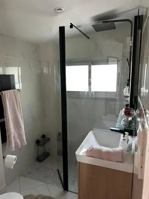 a bathroom with a tub and a sink and a shower at Le cabanon du Cannet in Le Cannet