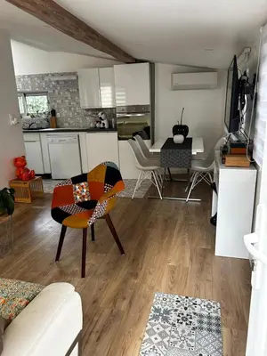 a living room with a kitchen and a dining room at Le cabanon du Cannet in Le Cannet