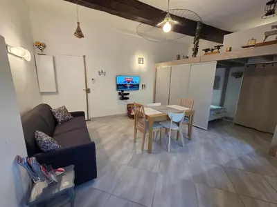 a living room with a couch and a table at Meynadier 66 - Appartement Très Calme avec Cour Privative, Plage, Gare, Palais à 300m in Cannes