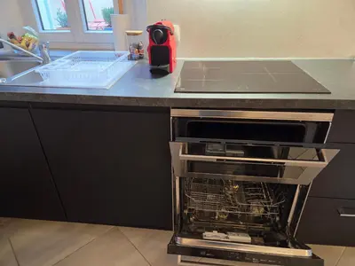 a kitchen with an oven with its door open at Meynadier 66 - Appartement Très Calme avec Cour Privative, Plage, Gare, Palais à 300m in Cannes