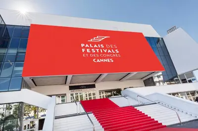 a building with a red sign on the side of it at Meynadier 66 - Appartement Très Calme avec Cour Privative, Plage, Gare, Palais à 300m in Cannes