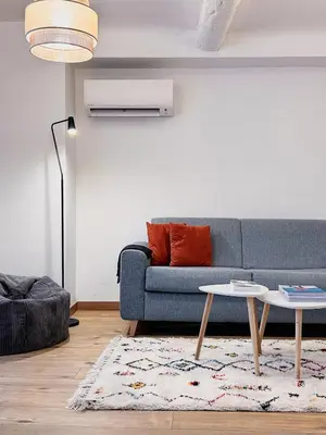 a living room with a blue couch and a table at Studio cosy et luxueux centre Cannes et proche plages in Cannes