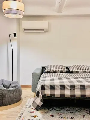 a bedroom with a bed with a plaid blanket at Studio cosy et luxueux centre Cannes et proche plages in Cannes