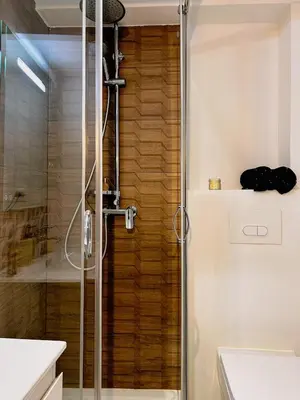 a shower with a glass door in a bathroom at Studio cosy et luxueux centre Cannes et proche plages in Cannes