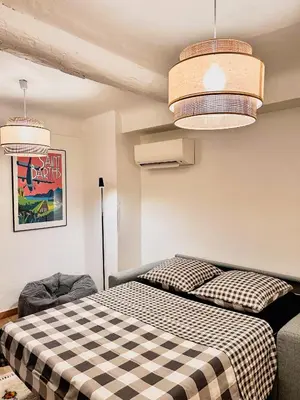 a bedroom with two beds and two pendant lights at Studio cosy et luxueux centre Cannes et proche plages in Cannes