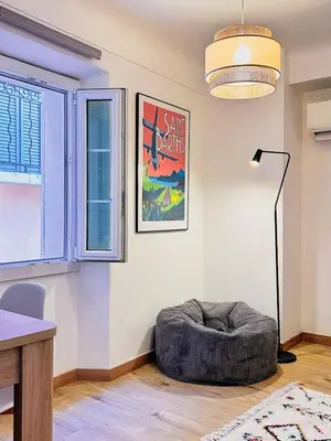 a living room with a bean bag chair and a window at Studio cosy et luxueux centre Cannes et proche plages in Cannes