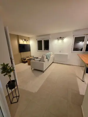 a living room with a couch and a table at Appartement rénové proche plage in Cannes