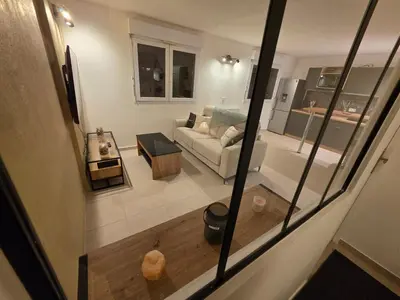 a living room with a couch and a kitchen at Appartement rénové proche plage in Cannes