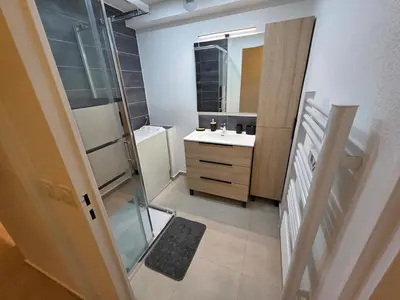 a hallway with a plant in the middle of a building at Appartement rénové proche plage in Cannes